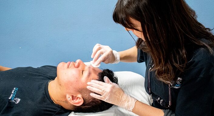 Woman applying a facial treatment
